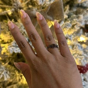 Sterling silver floral ring with pinkish/purple cabochon center piece.